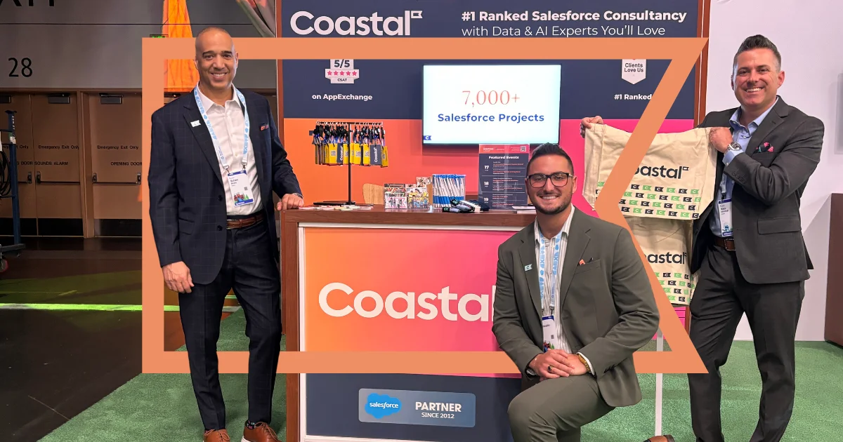 Three Coastal employees in front of the Coastal booth at the Dreamforce Campground.