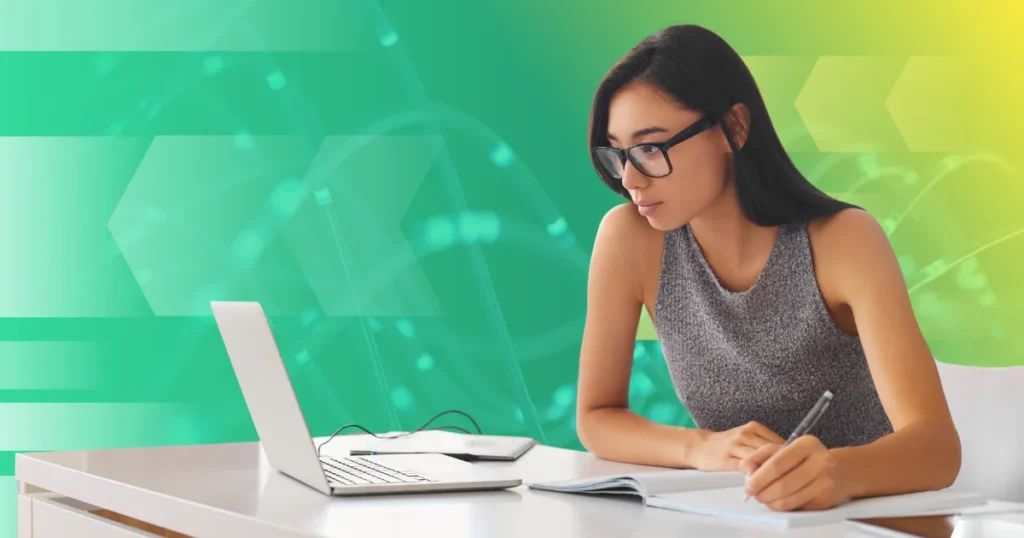 Woman at a computer taking notes