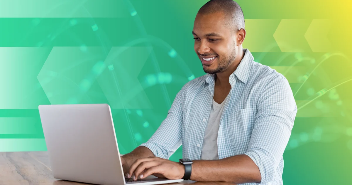 Man using a computer with a green and yellow background