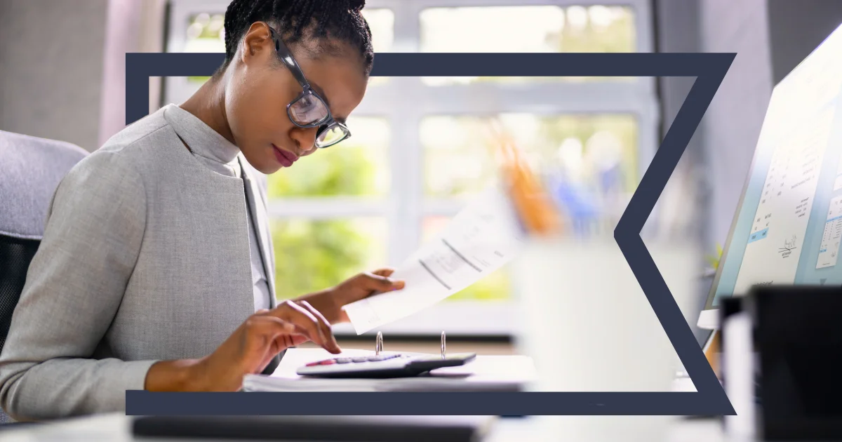 Woman working with a calculator at her desk