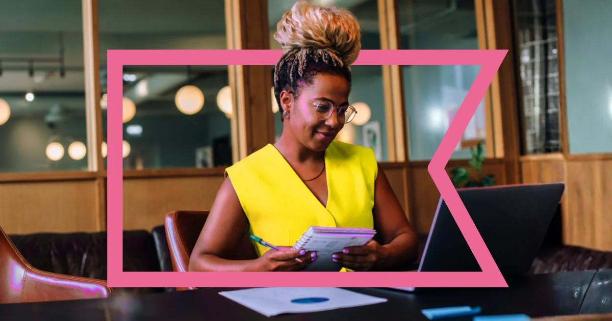 Black woman in a yellow dress reading about AI business trends in Coastal's AI Operations Report